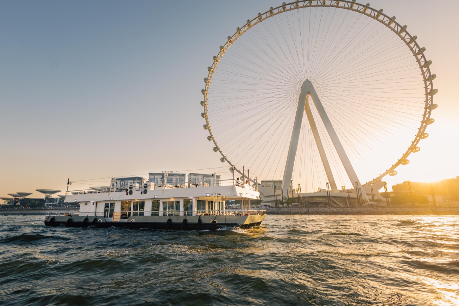 Golden sunset cruise with Ain Dubai in the background