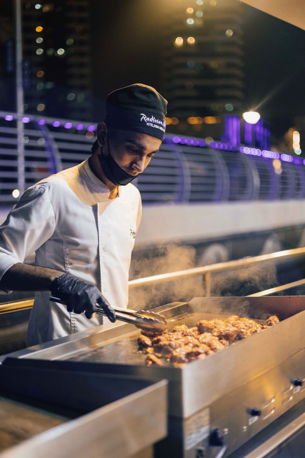 Live cooking station with chef preparing fresh dishes