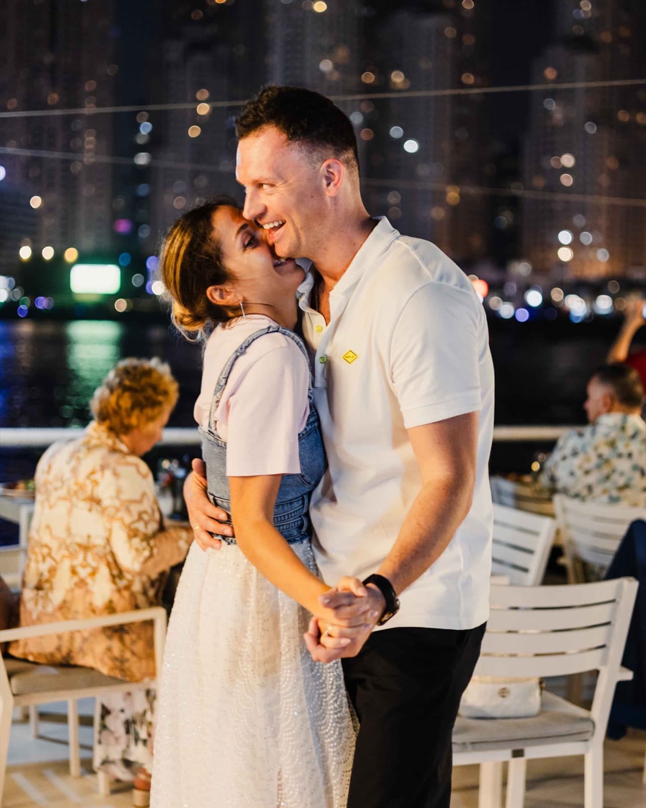 Couple dancing under the lights on the upper deck